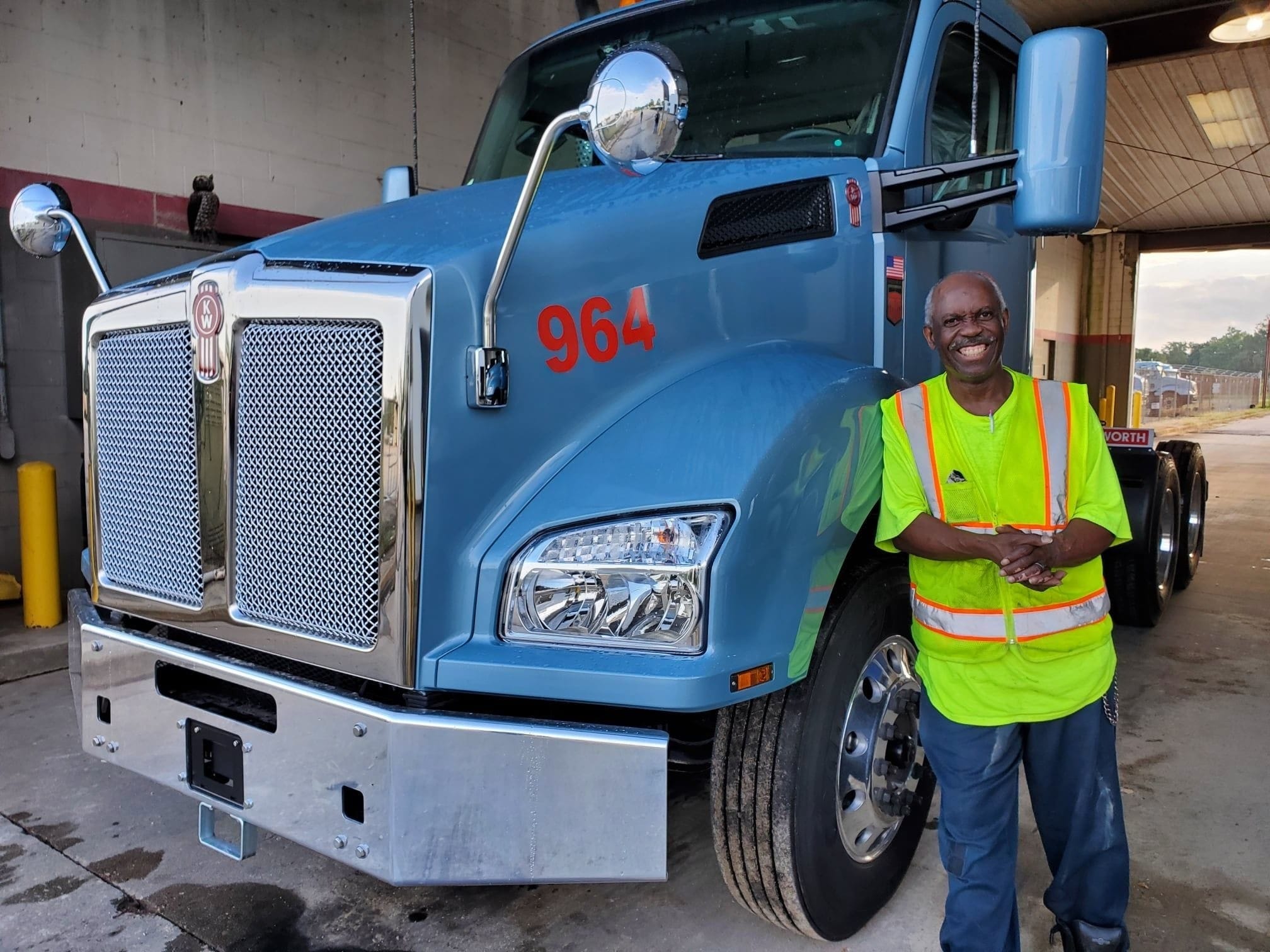 Man Smiling in Front of a Truck